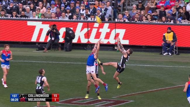 Collingwood's Jeremy Howe takes a mark over Melbourne's Tom McDonald. This was judged to be a free kick for McDonald.