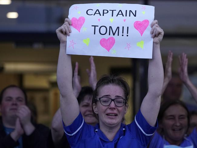 A nurse sheds a tear as she pays tribute to super fundraiser Captain Tom Moore. Picture: Getty