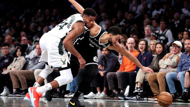 Simmons competes for the ball with Giannis Antetokounmpo. (Photo by Luke Hales/Getty Images via AFP)