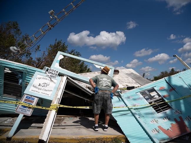 John Vest looks at his storm damaged business at Fish Trap Marina in Bonita Springs, Florida. Picture: Sean Rayford/Getty Images/AFP