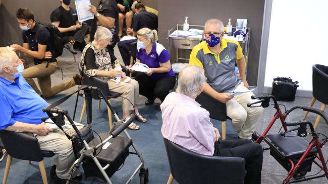 Scott Morrison speaks to fellow recipients of the COVID-19 vaccination in the observation area at Castle Hill Medical Centre on February 21. Picture: Mark Evans / Getty Images