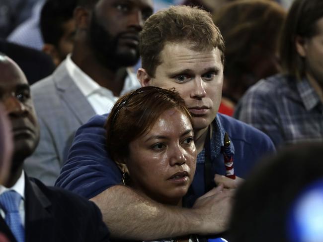 Leaning on each other. Supporters react to election results at the Jacob Javits Center glass enclosed lobby in New York. Picture: Frank Franklin II/AP