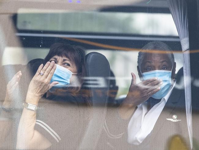 United Airlines crew members wave and blow kisses as they depart the Novotel Hotel in Darling Harbour on Thursday. Picture: Getty