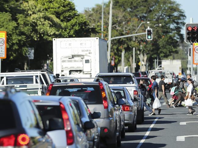 Traffic at pick up time at Macgregor State School. The story is about 1300 drivers being fined by the council in term 1 for parking illegally around schools. The council and state government are also locked in a stand-off over who builds the new drop-off zone at Macgregor SS. Pic Mark Cranitch.