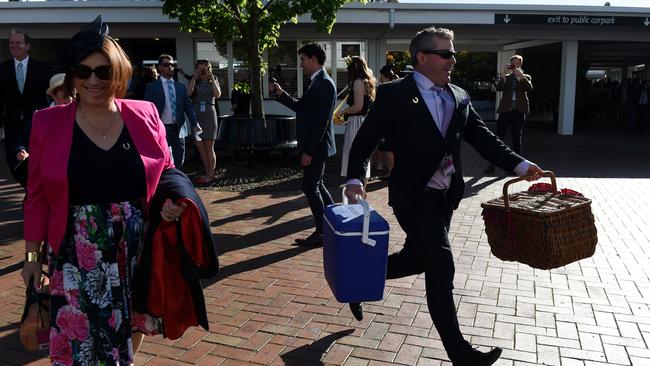 Punters run through the Flemington gates this morning to get the best position to watch the Melbourne Cup. Picture: AAP