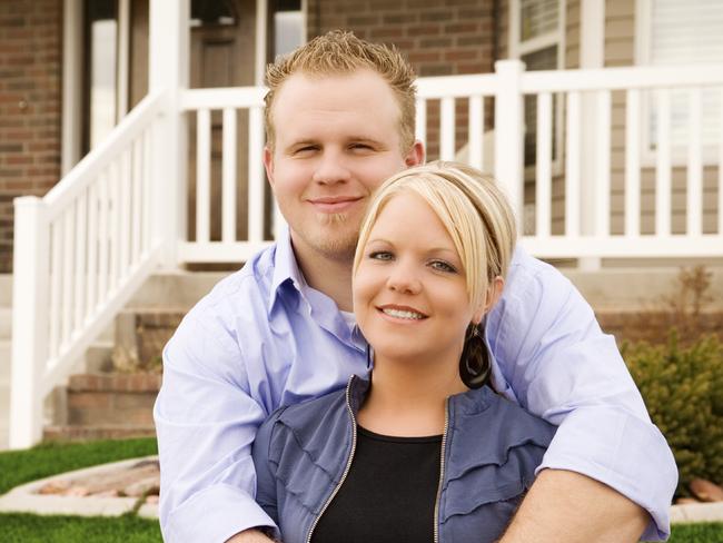 Couple outside a new home and they are paying off their mortgage. Picture: iStock.