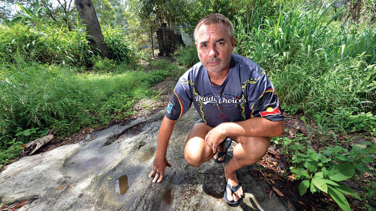 'OUR LAND': Kabi land rights claimant Wit-boooka shows hollows in the surface rock of the ridge, which he says his people used to grind seeds. Picture: Patrick Woods