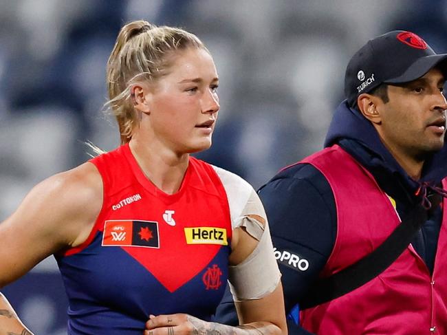 GEELONG, AUSTRALIA - AUGUST 31: Tayla Harris of the Demons leaves the field with medical staff during the 2024 AFLW Round 01 match between the Geelong Cats and the Melbourne Demons at GMHBA Stadium on August 31, 2024 in Geelong, Australia. (Photo by Dylan Burns/AFL Photos via Getty Images)