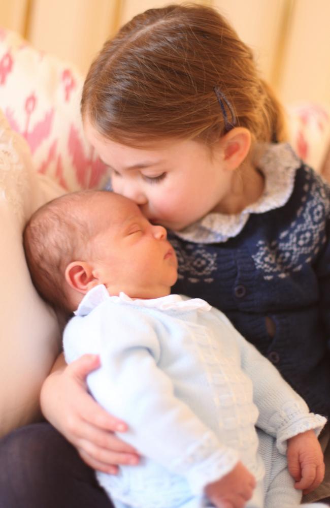 Princess Charlotte cradles her little brother, Prince Louis, on her third birthday. Picture: Duchess of Cambridge/MEGA