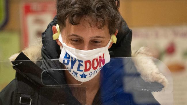 A man wears a "Bye Don" mask as he arrives to vote in Chelsea in New York City. Picture: AFP