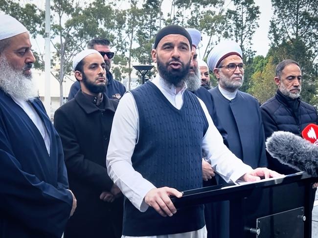 Representatives of the Australian Muslim Community, including Grand Mufti of Australia Sheikh Riad El-Refai, and parents of the seven minors charged with terror-related offences, gather at Paul Keating Park in Bankstown, to call for an inquiry into the charges. The speaker is Sheikh Wesam Charkawi. Picture - Joanna Panagopoulos