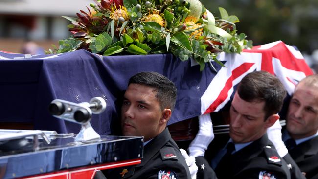 Mr Kidd is carried into the church by the Ceremonial Team of Fire and Rescue. Picture: NCA NewsWire / Damian Shaw