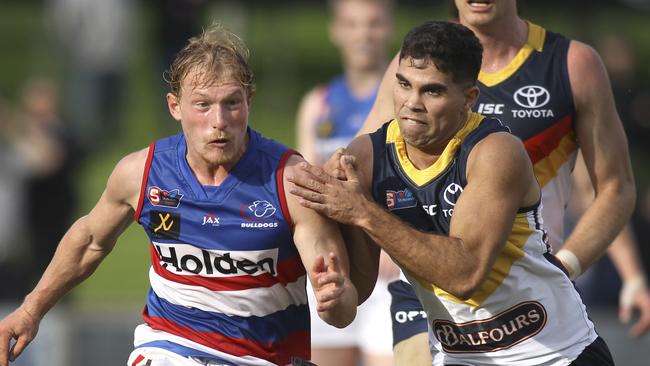 Central’s Travis Schiller gets a kick under pressure from Crow Tyson Stengle. Picture: AAP Image/Dean Martin