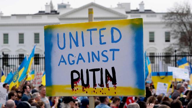 A demonstrator holds a United Against Putin sign outside the White House in Washington. Picture: Stefani Reynolds / AFP