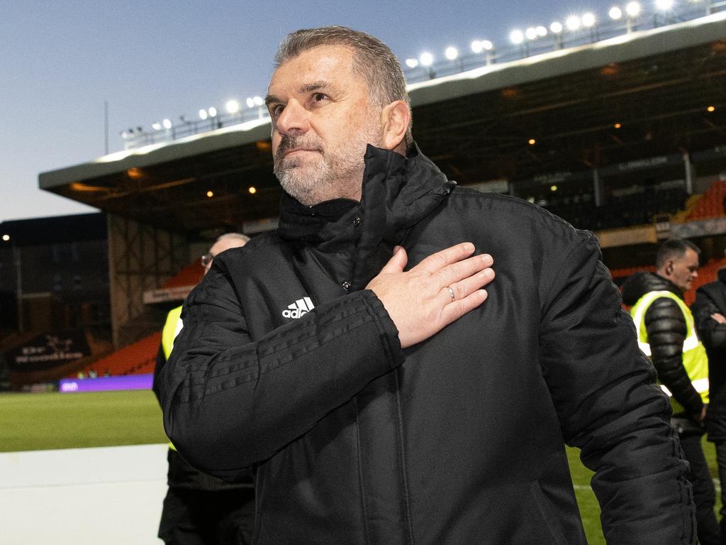 Celtic manager Ange Postecoglou celebrates winning the league by making a trademark gesture, touching the club’s crest on his jacket. Picture: Craig Williamson/SNS Group via Getty Images