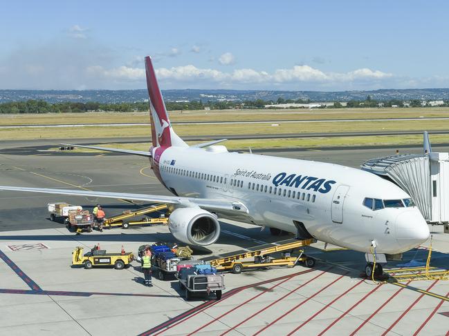 Qantas airport baggage handlers wearing protective gear while the supervisor (Not Sure) but looks as if he was giving orders was not wearing any protective gear at all and was not practising safe distance rules.Thursday April 2 2020.PIC SUPPLIED