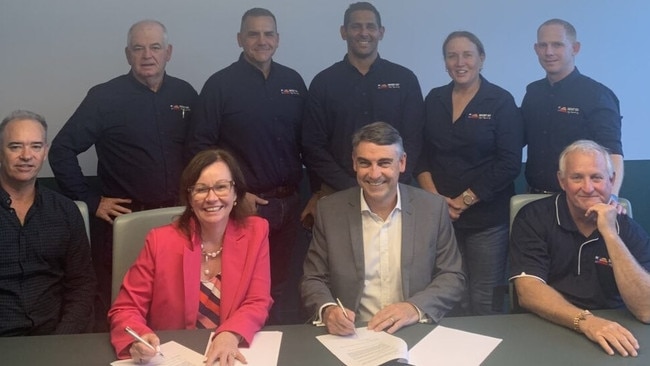 The Mount Isa City Council chief executive Tim Rose, Mayor Peta MacRae and the councillors sign an MOU with Green Gravity CEO Mark Swinnerton.