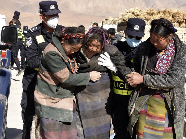 Rescuers transfer the injured at Zhacun Village of Dingri County in Xigaze. Picture: Xinhua via AP