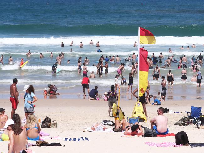 Scenes in  Surfers Paradise as a large number of people visit the Beach and Cavill Avenue .Photograph : Jason O'Brien