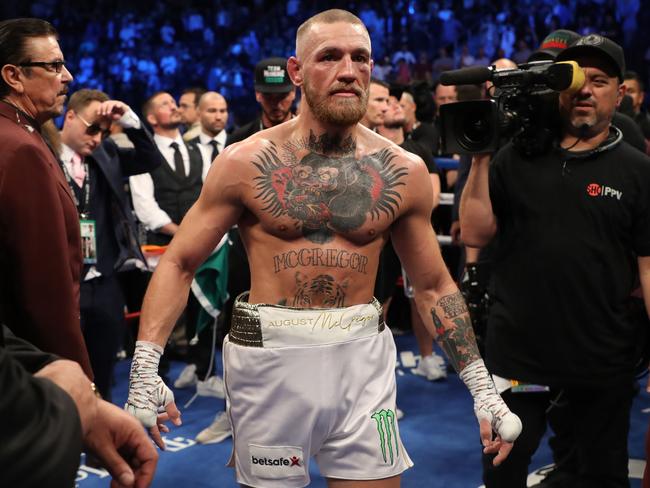 Conor McGregor stands in the ring after being defeated by Floyd Mayweather Jr.