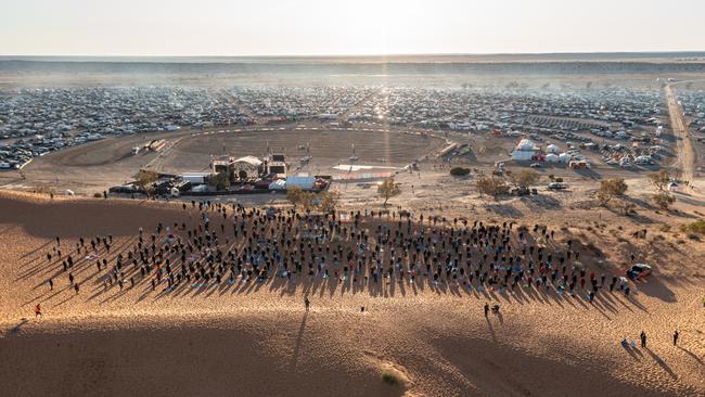 Sunrise yoga atop Big Red on Wednesday, where 507 ‘outback yogis’ set a new Australian record for The Most People Practicing Yoga on a Red Sand Dune. Picture: Matt Williams