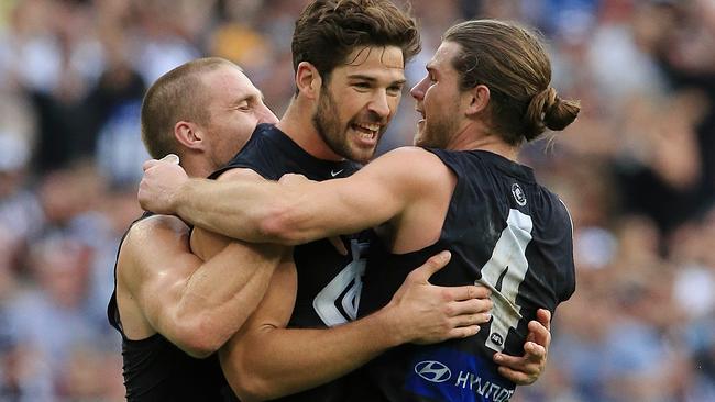 Levi Casboult celebrates the win over Collingwood with Zach Tuohy and Bryce Gibbs. Picture: Wayne Ludbey