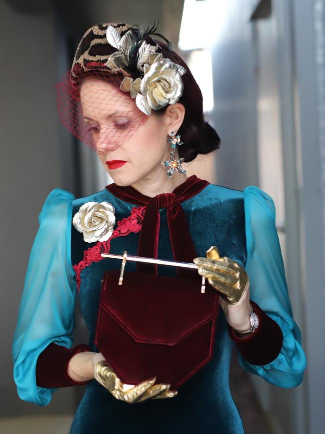 Raceway fashion has moved online with Andergrove resident Anna Dutton taking part in the Virtual Fashions Off The Field competition. Ms Dutton created both her hat and her teal and wine velvet dress.