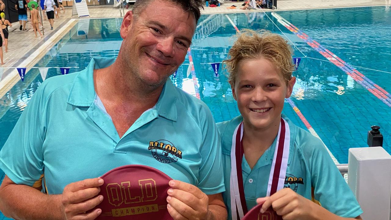 SWIMMING SENSATION: Bailey Harm with coach Andrew Fidge (left) and his three gold medals at last year’s Sprint Championships.