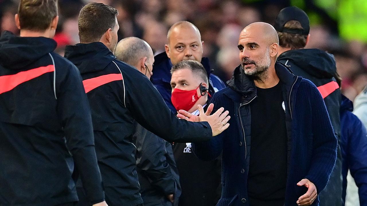 Manchester City's Spanish manager Pep Guardiola speaks to players at the end of the English Premier League football match between Liverpool and Manchester City at Anfield in Liverpool, northwest England, on October 3, 2021. (Photo by Paul ELLIS / AFP) / RESTRICTED TO EDITORIAL USE. No use with unauthorised audio, video, data, fixture lists, club/league logos or 'live' services. Online in-match use limited to 120 images. An additional 40 images may be used in extra time. No video emulation. Social media in-match use limited to 120 images. An additional 40 images may be used in extra time. No use in betting publications, games or single club/league/player publications. /