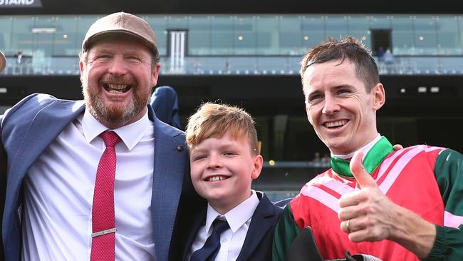 Trainer Gary Portelli with his son, Harper, and jockey Jason Collett celebrate the win of Kimochi in the Light Fingers Stakes at Randwick. Picture: Getty Images