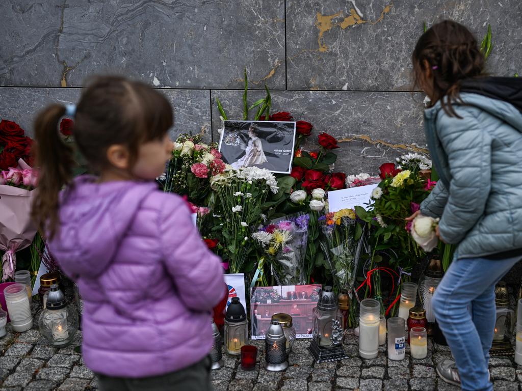 Children lay flowers for the late Queen Elizabeth II at the British Embassy in Warsaw, Poland. Picture: Getty.