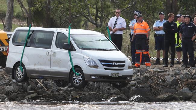 The family’s van is lifted out of the river. Picture: Glenn Hampson