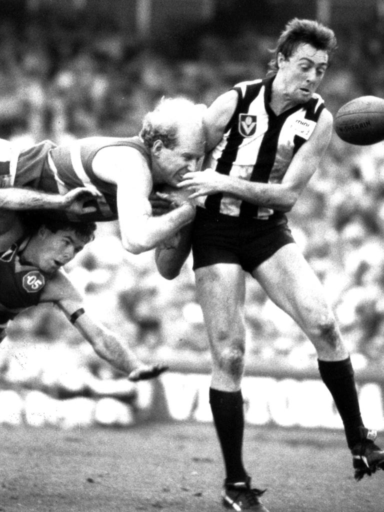 Simon Beasley slams headlong into Mick McGuane.