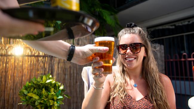 Some NT hospitality venues may not reopen on May 15 or haven’t decided, but some like the Cavenagh Hotel will – and they’ll have fresh beer. Pictured is Danielle Jones getting a schooner by the Cav’s pool. Picture: Che Chorley