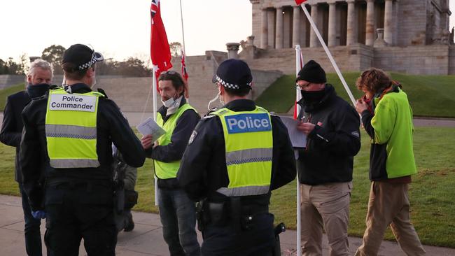 Police speak to anti-mask protesters on the forecourt of the Shrine of Remembrance. Picture: NCA NewsWire /David Crosling