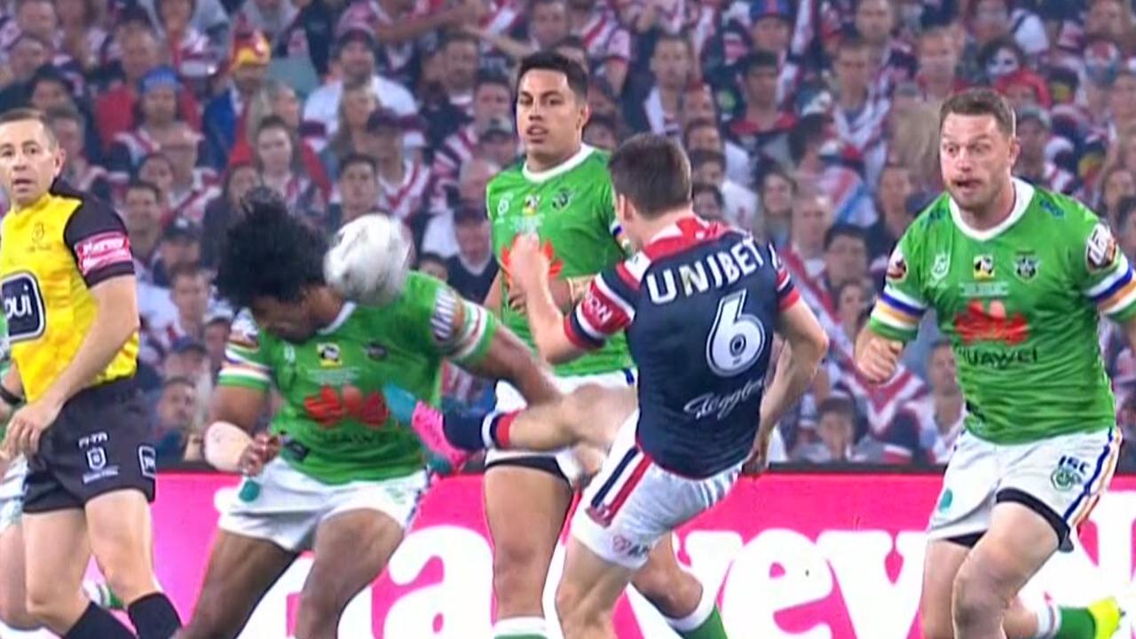 Sia Soliola attempts a charge down, but it hit the Roosters trainer.