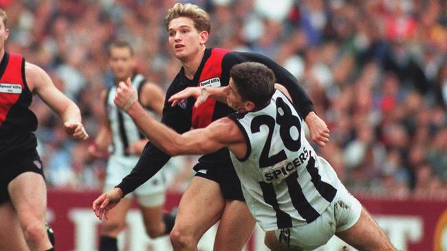 James Hird and Gavin Crosisca battle it out.