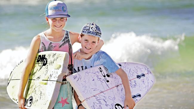 Chloe Gould, 12, and brother Samuel, 9 are collecting signatures of the pro surfers the Quiksilver and Roxy Pro. Picture: Luke Marsden.