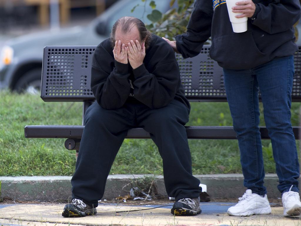 David Thevo of Kansas City, is consoled by a friend at nearby Lally Park. Picture: Tammy Ljungblad/The Kansas City Star via AP