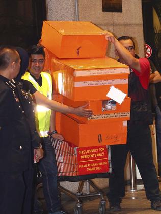 Police load ex-PM Najib Razak and wife Rosmah Mansor’s stash of cash and valuables in a raid last week. 