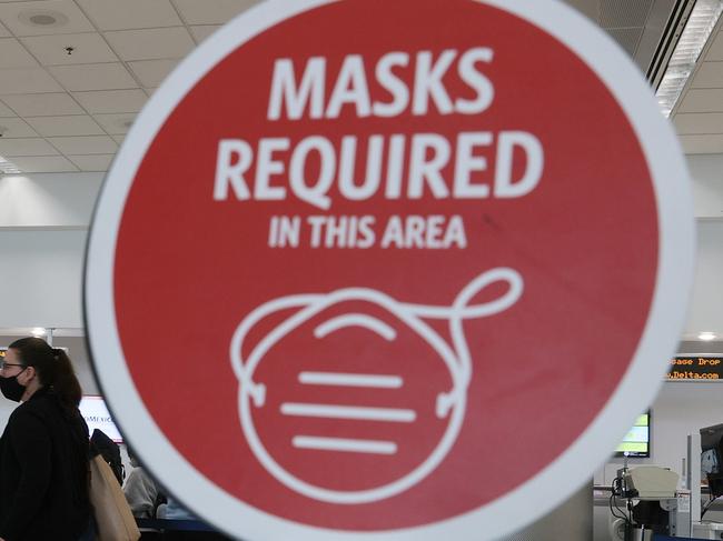 MIAMI, FLORIDA - FEBRUARY 01: A sign reading, 'masks required in this area,' is seen as travelers prepare to check-in for their Delta airlines flight at the Miami International Airport on February 01, 2021 in Miami, Florida. An executive order signed by U.S. President Joe Biden last week mandates mask-wearing on federal property and on public transportation as part of his plan to combat the coronavirus (COVID-19) pandemic.   Joe Raedle/Getty Images/AFP == FOR NEWSPAPERS, INTERNET, TELCOS & TELEVISION USE ONLY ==