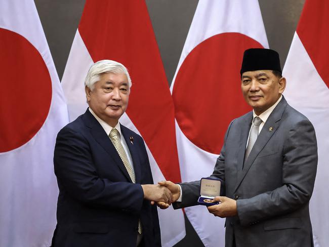 This handout photo taken on January 7, 2025 and released on January 8, 2025 by the Indonesian Defence Ministry shows Indonesia's Defence Minister Sjafrie Sjamsoeddin (R) shaking hands with Japan's Defense Minister Gen Nakatani during their meeting at the Defence Ministry in Jakarta. (Photo by Handout / INDONESIAN DEFENCE MINISTRY / AFP) / RESTRICTED TO EDITORIAL USE - MANDATORY CREDIT "AFP PHOTO / INDONESIAN DEFENCE MINISTRY" - NO MARKETING NO ADVERTISING CAMPAIGNS - DISTRIBUTED AS A SERVICE TO CLIENTS