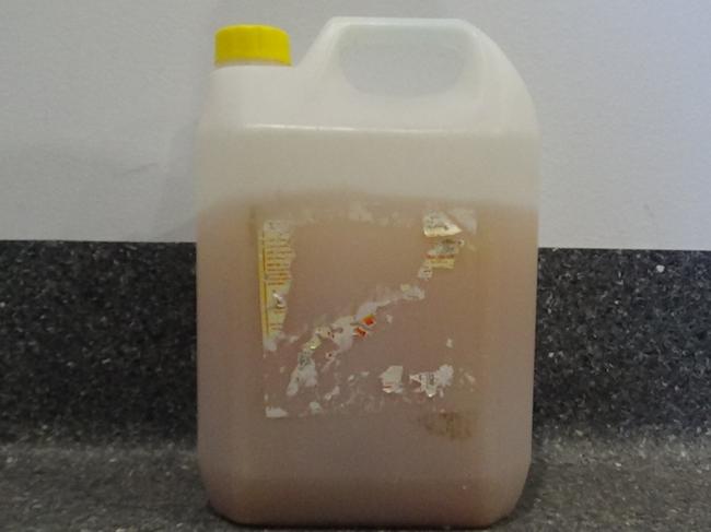 Hidden under a prisoner’s bed – four litres of jail-made brew made from fermented apples in an old disinfectant bottle. Picture: Corrective Services NSW