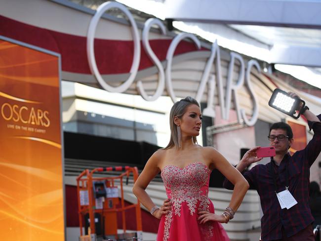 Journalists and presenters prepare on the red carpet area for this year's Oscars Awards ceremony in Hollywood, California on February 23, 2019. - The Academy Awards annual ceremony will take place on February 24 2019. (Photo by Mark RALSTON / AFP)