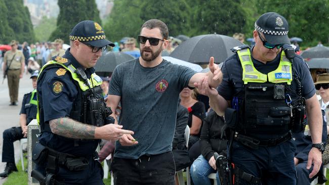 An anti-lockdown protestor is removed by police during the Remembrance Day service at the Shrine of Remembrance in Melbourne. Picture: NCA NewsWire / Andrew Henshaw