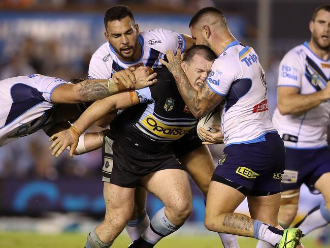 Paul Gallen is tackled by the Titans defence.