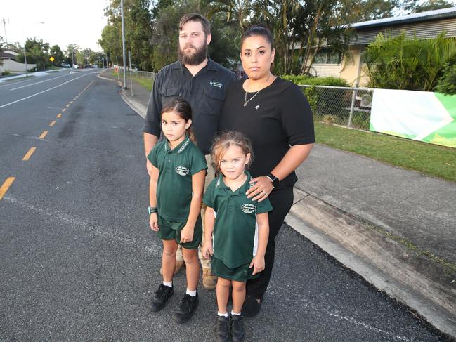 Andrew Hall and Suzanne Hall with their children Georgia and Chloe at 'kiss and go' zone outside Helensvale State School. Picture: Glenn Hampson.