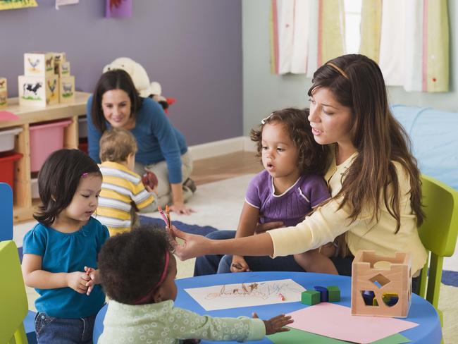 Teachers and toddlers in daycare.Preschool, Nursery School Building, Child, Child Care, Education, Teacher, Toddler, Learning, Messing About, Playing, Teaching, Childhood, Boys, Assistance, Latin American and Hispanic, Table, Toy, Group Of People,  Fun, Multiracial Group, Friendship, Girls, People, Adult, Indoors, Occupation, 18-23 Months, 25-29 Years, 30-39 Years, African-American Ethnicity, Asian, Blonde Hair, Brown Hair, Caucasian Appearance, Cheerful, Colour Image, Colouring, Crayon, Cute, Daycare, Filipino, Growth, Horizontal, Large Group Of People, Latin, Thinkstock, Generic, Childcare