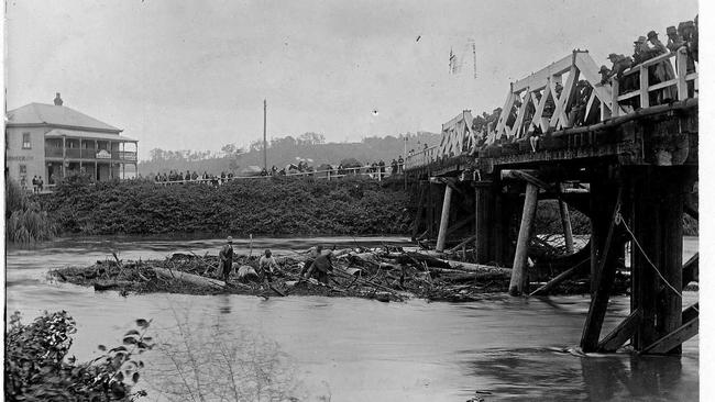 CLEARING TIMBER BROUGHT DOWN BY A FLOOD; Coleman's Bridge over Leycester Creek. The Junction Hotel (later the Winsome Hotel) managed by christie Griifin for a time, in the background.Photo Contributed (supplied TG Hewitt). Picture: Contributed