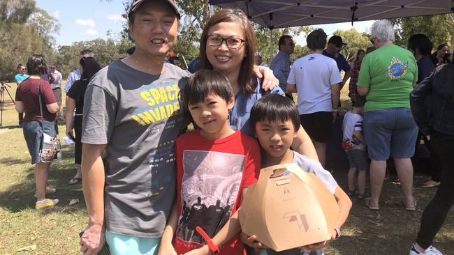 Crestmead’s Nguyen family with a box of one of the first drone deliveries in Queensland.